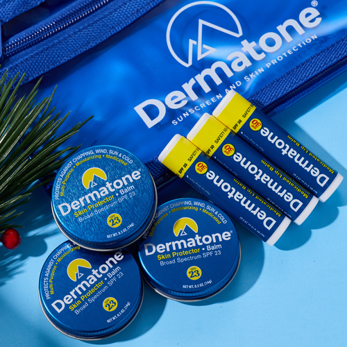 laydown of three tins and three lip balms with a blue bag on blue
