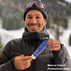 Pro Skier Marcus Caston holding Deramtone Sport SPF50 Suncsreen