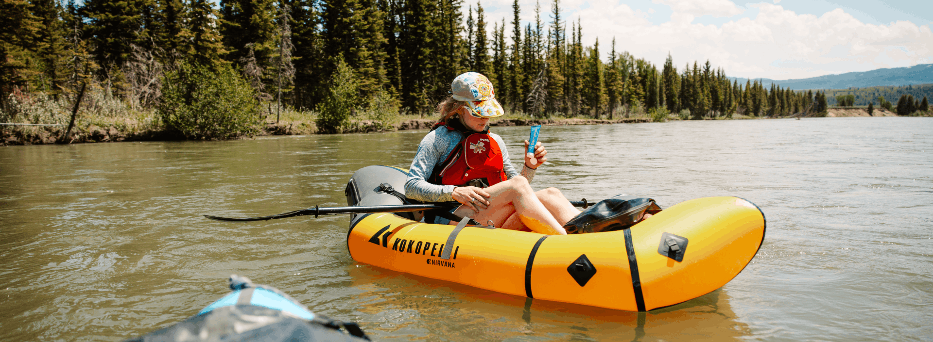 a woman in a packraft on a river
