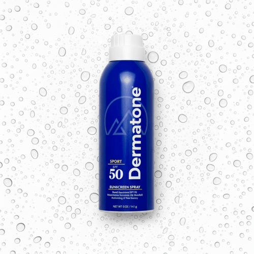 A bottle of the Dermatone sport sunscreen spray, surrounded by droplets on a white background