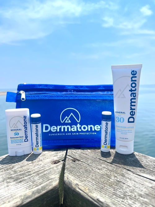 Reef Safe Sunscreen Travel Pack sitting on a wooden railing with an ocean background